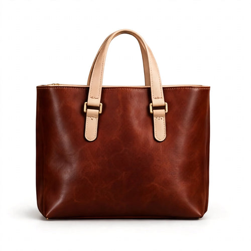A brown leather tote bag with light beige handles and buckle details, shown against a plain white background.